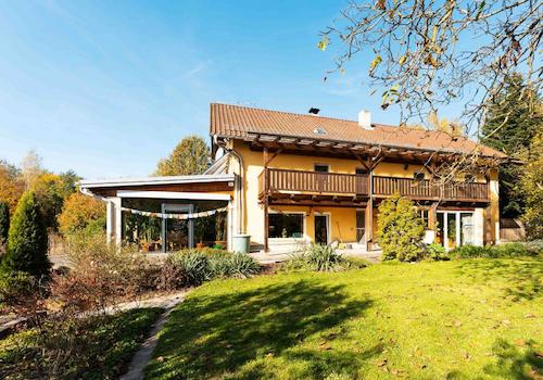 Die östliche Ansicht auf das Haus mit Balkon und Wintergarten