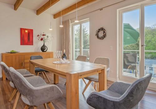 neben dem großen Esstisch führen zwei Türen ...