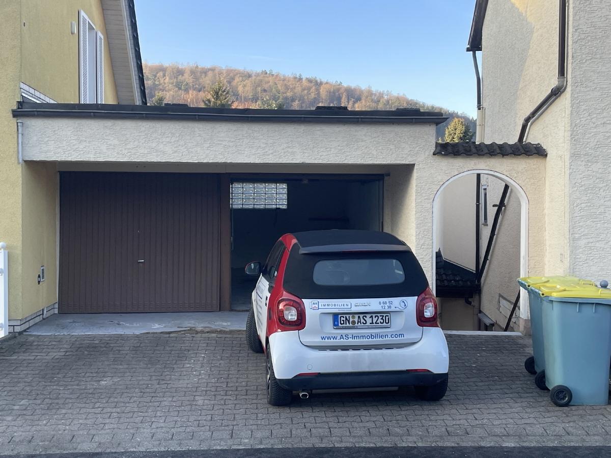 Garage links und Stellplatz davor