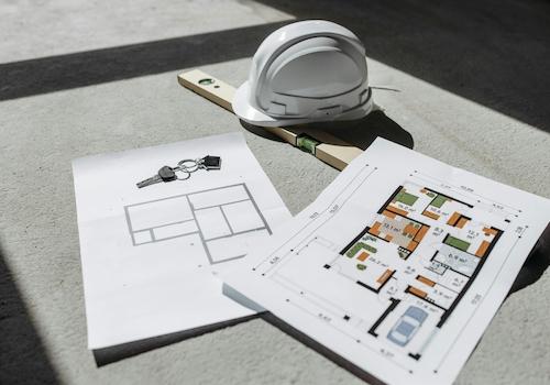 architectural-floor-plans-with-helmet-and-keys-on-sunlit-floor-perfect-for-real-estate-or-construction-themes-NWpfICtzGTtnATUnEGfGew
