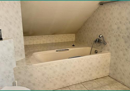 Großes Badezimmer mit Badewanne und