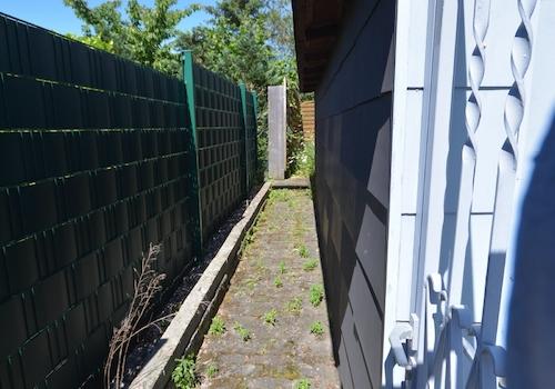 Seitlicher Zugang zum Garten mit angebautem Geräteraum 