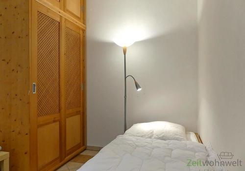 Bett und Kleiderschrank links